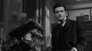 Movie still from “America America” (1963), directed by Elia Kazan – A man and a woman standing next to each other in a room; Close Up shot, Over the shoulder angle
