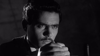 Movie still from “America America” (1963), directed by Elia Kazan – A black and white photo of a man in a suit; Close Up shot, Low angle