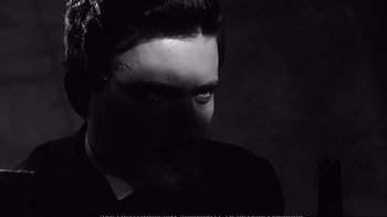 Movie still from “America America” (1963), directed by Elia Kazan – A black and white photo of a man in a suit and tie; Close Up shot, Over the shoulder angle