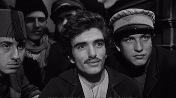 Movie still from “America America” (1963), directed by Elia Kazan – Black and white photograph of a group of men; Close Up shot, High angle