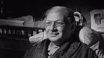 Movie still from “America America” (1963), directed by Elia Kazan – An older man wearing glasses and a jacket; Close Up shot, Over the shoulder angle