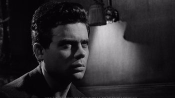 Movie still from “America America” (1963), directed by Elia Kazan – Black and white photograph of a young man looking at the camera; Close Up shot, Over the shoulder angle