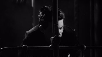 Movie still from “America America” (1963), directed by Elia Kazan – A black and white photo of a man looking through a window; Close Up shot, High angle