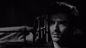 Movie still from “America America” (1963), directed by Elia Kazan – A black and white photo of a man with a mustache; Close Up shot, Over the shoulder angle