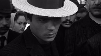 Movie still from “America America” (1963), directed by Elia Kazan – A black and white photo of a man wearing a straw hat; Close Up shot, High angle