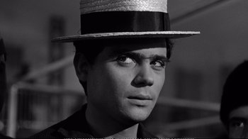 Movie still from “America America” (1963), directed by Elia Kazan – A man wearing a top hat and a black shirt; Close Up shot, Low angle