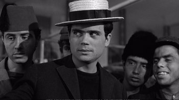 Movie still from “America America” (1963), directed by Elia Kazan – A black and white photo of a man wearing a hat; Close Up shot, Low angle