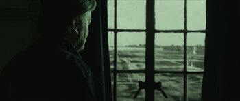 Movie still from “American Dharma” (2018), directed by Errol Morris – A man standing in front of an open window; Close Up shot, Over the shoulder angle