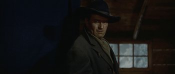 Movie still from “American Dharma” (2018), directed by Errol Morris – A man wearing a black hat and a black jacket; Medium shot, Low angle