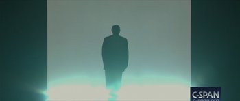 Movie still from “American Dharma” (2018), directed by Errol Morris – A man in a suit standing in the middle of the night; Extreme Wide shot, Low angle