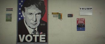 Movie still from “American Dharma” (2018), directed by Errol Morris – A poster of donald trump is on the wall; Extreme Close Up shot, Low angle