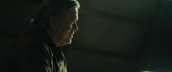 Movie still from “American Dharma” (2018), directed by Errol Morris – A person looking to the side; Close Up shot, Low angle