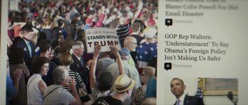 Movie still from “American Dharma” (2018), directed by Errol Morris – A crowd of people gathered together holding signs; Extreme Close Up shot, High angle