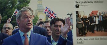 Movie still from “American Dharma” (2018), directed by Errol Morris – A group of men standing next to each other waving; Medium shot, Low angle