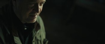 Movie still from “American Dharma” (2018), directed by Errol Morris – A man's face in the dark; Close Up shot, Over the shoulder angle