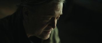 Movie still from “American Dharma” (2018), directed by Errol Morris – An older woman is looking down at her face; Close Up shot, Low angle