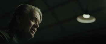 Movie still from “American Dharma” (2018), directed by Errol Morris – An older man with white hair looking to his left; Close Up shot, Low angle