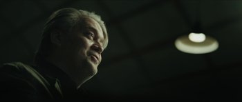 Movie still from “American Dharma” (2018), directed by Errol Morris – An older man with white hair looking upward; Close Up shot, Low angle