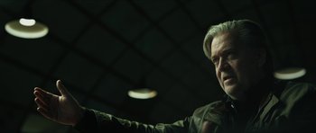 Movie still from “American Dharma” (2018), directed by Errol Morris – A man in a dark room pointing at the camera; Close Up shot, Low angle