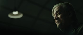 Movie still from “American Dharma” (2018), directed by Errol Morris – An older man with white hair is looking at the camera; Close Up shot, Low angle