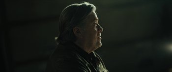 Movie still from “American Dharma” (2018), directed by Errol Morris – An older man with long white hair looking to his left; Close Up shot, Low angle