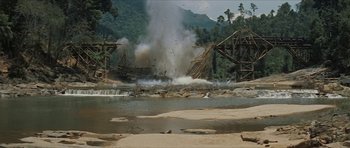 Movie still from “American Dharma” (2018), directed by Errol Morris – An image of a bridge being destroyed in the middle of the day; Extreme Wide shot, Low angle