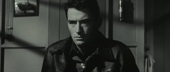 Movie still from “American Dharma” (2018), directed by Errol Morris – Black and white photograph of a man wearing a leather jacket; Close Up shot, Over the shoulder angle