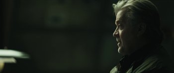 Movie still from “American Dharma” (2018), directed by Errol Morris – An older man is looking to his left; Close Up shot, Over the shoulder angle