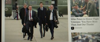 Movie still from “American Dharma” (2018), directed by Errol Morris – A group of men in suits and ties walking down a sidewalk; Medium shot, Low angle