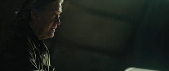 Movie still from “American Dharma” (2018), directed by Errol Morris – An older man is looking to his left; Close Up shot, Over the shoulder angle
