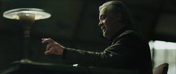Movie still from “American Dharma” (2018), directed by Errol Morris – An older man is playing the piano in a dark room; Close Up shot, Low angle