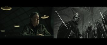 Movie still from “American Dharma” (2018), directed by Errol Morris – A man sitting in front of an open umbrella; Medium shot, Low angle