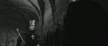Movie still from “American Dharma” (2018), directed by Errol Morris – A man wearing a crown standing in front of a crowd; Medium shot, Low angle