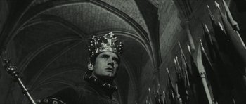 Movie still from “American Dharma” (2018), directed by Errol Morris – A black and white photo of a man wearing a crown; Close Up shot, Low angle