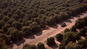 Movie still from “American Gigolo” (1980), directed by Paul Schrader – An aerial view of a car driving down the road; Extreme Wide shot, Overhead angle