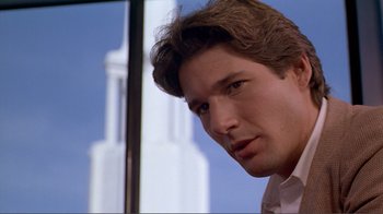 Movie still from “American Gigolo” (1980), directed by Paul Schrader – A person wearing a white dress shirt; Close Up shot, Low angle