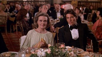 Movie still from “American Gigolo” (1980), directed by Paul Schrader – A woman and a man sitting at a dinner table; Medium shot, Over the shoulder angle
