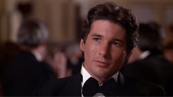 Movie still from “American Gigolo” (1980), directed by Paul Schrader – A person wearing a suit and tie; Close Up shot, Low angle