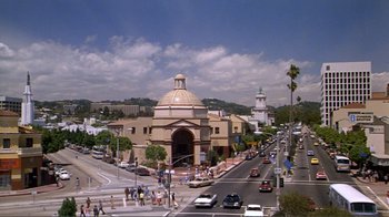 Movie still from “American Gigolo” (1980), directed by Paul Schrader – A view of a street with a church in the middle of the street; Extreme Wide shot, High angle