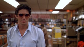 Movie still from “American Gigolo” (1980), directed by Paul Schrader – A man wearing sunglasses and a white shirt; Close Up shot, Low angle