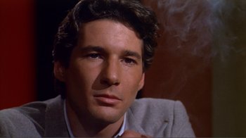 Movie still from “American Gigolo” (1980), directed by Paul Schrader – A person wearing a suit and tie; Close Up shot, High angle