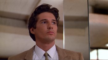 Movie still from “American Gigolo” (1980), directed by Paul Schrader – A person wearing a suit and tie; Close Up shot, Low angle