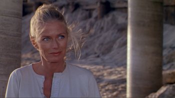 Movie still from “American Gigolo” (1980), directed by Paul Schrader – A woman in a white shirt is standing on the beach; Close Up shot, Over the shoulder angle