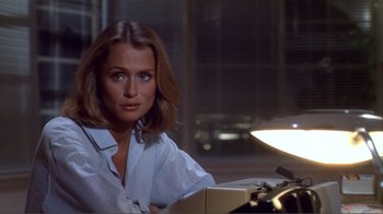 Movie still from “American Gigolo” (1980), directed by Paul Schrader – A woman sitting in front of a lamp in a dimly - lit room; Close Up shot, Over the shoulder angle