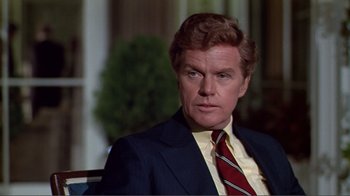 Movie still from “American Gigolo” (1980), directed by Paul Schrader – A person wearing a suit and a tie; Close Up shot, Over the shoulder angle