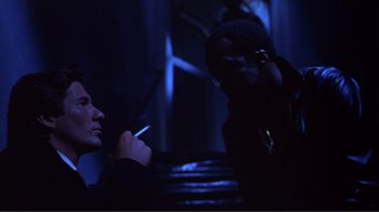 Movie still from “American Gigolo” (1980), directed by Paul Schrader – Two men are talking on a cell phone; Close Up shot, Low angle