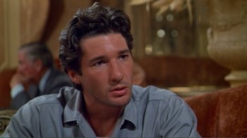 Movie still from “American Gigolo” (1980), directed by Paul Schrader – A person wearing a blue shirt; Close Up shot, Over the shoulder angle