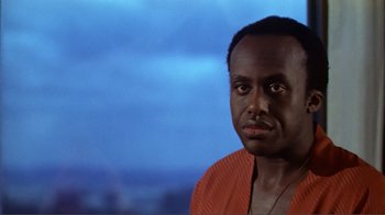 Movie still from “American Gigolo” (1980), directed by Paul Schrader – A person wearing a red shirt; Close Up shot, Low angle