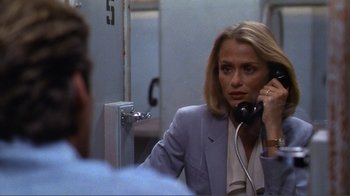 Movie still from “American Gigolo” (1980), directed by Paul Schrader – A woman talking on a phone in front of a mirror; Close Up shot, Over the shoulder angle