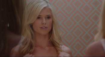 Movie still from “American Made” (2017), directed by Doug Liman – A beautiful blonde woman with long blonde hair; Close Up shot, Over the shoulder angle